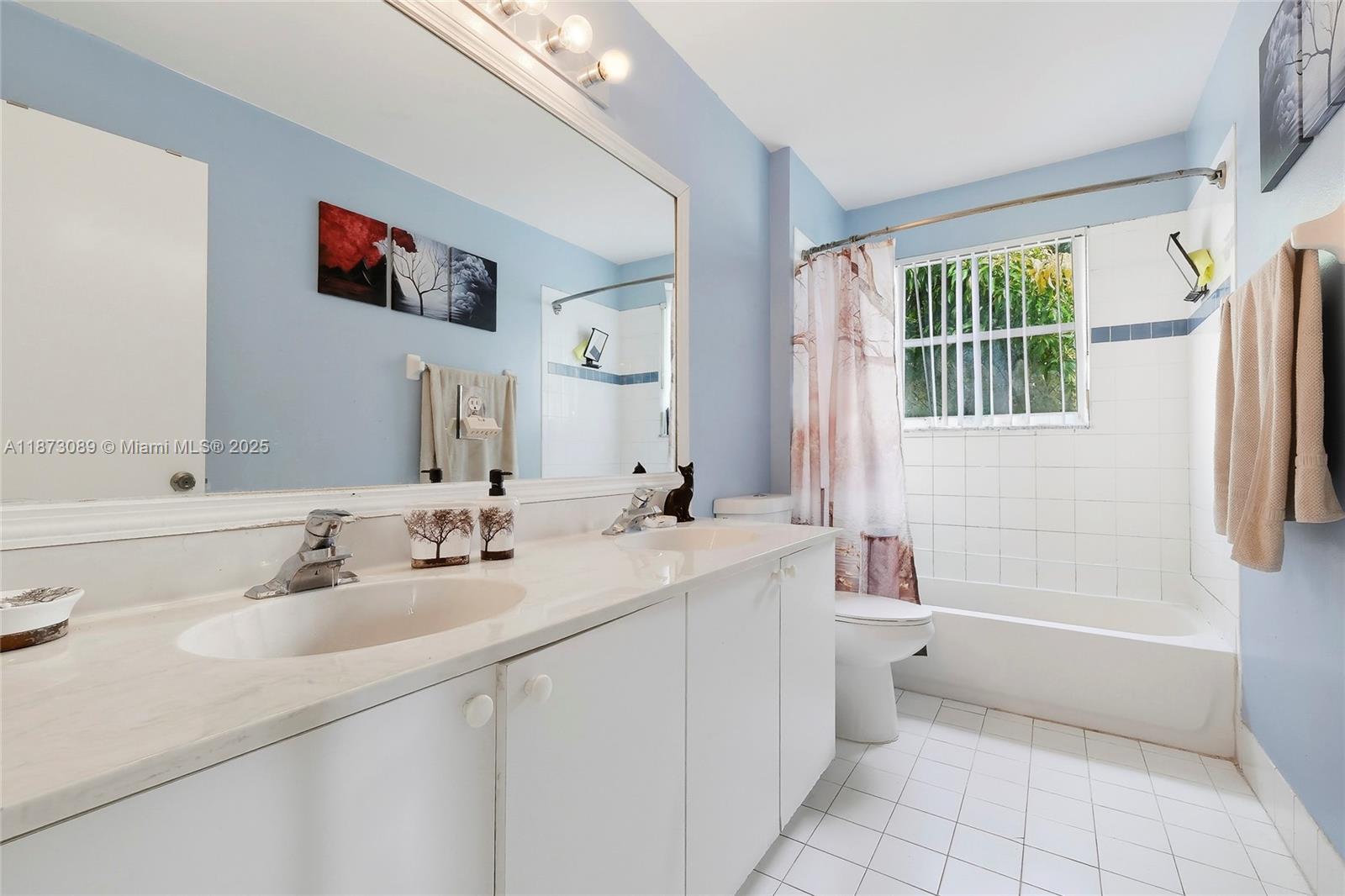 15025 Southwest 19th Court Miramar, FL 33027 - Photo 19 of 28 a bathroom with a tub sink and mirror