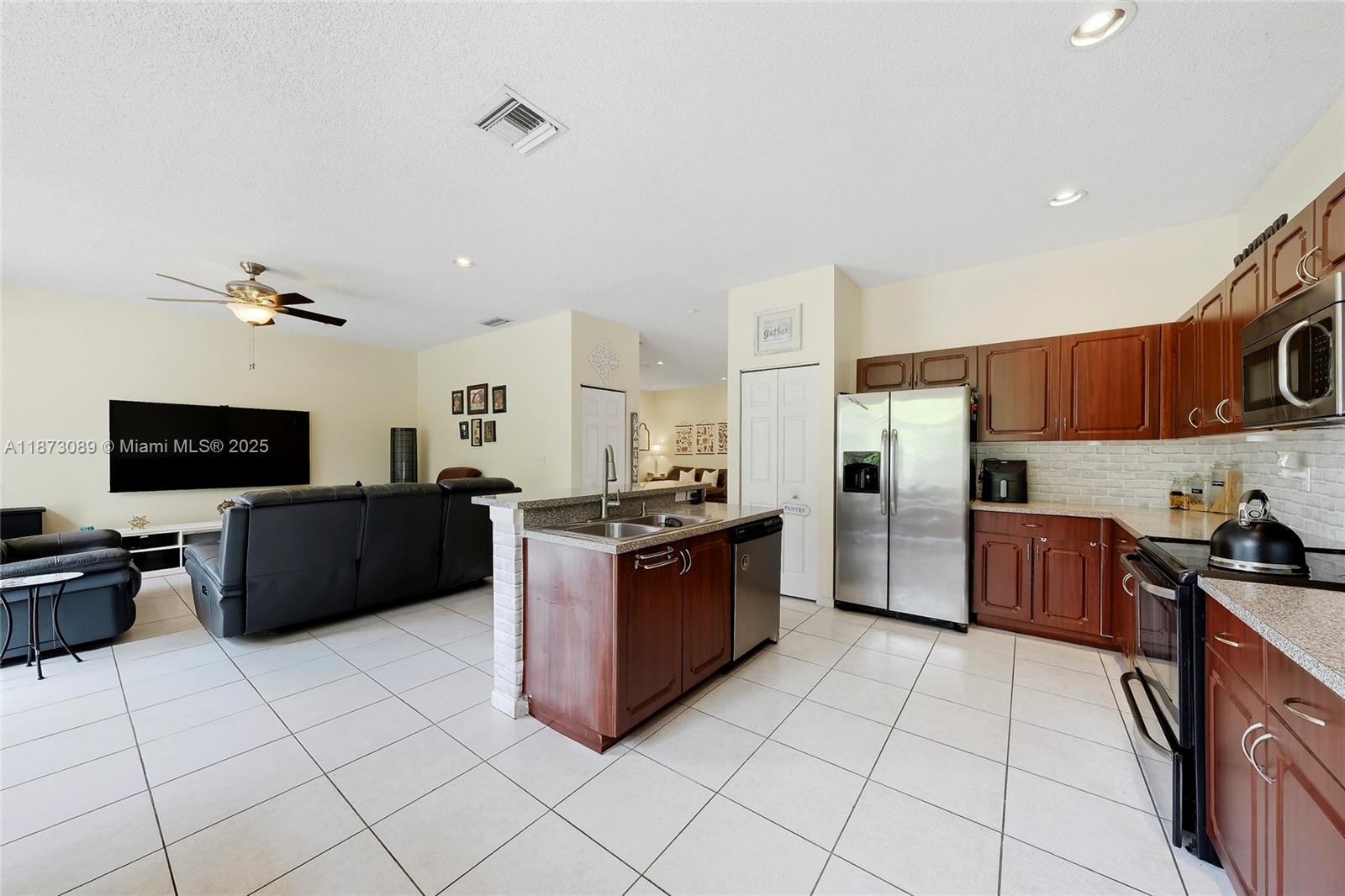 15025 Southwest 19th Court Miramar, FL 33027 - Photo 2 of 28 a large kitchen with stainless steel appliances granite countertop a refrigerator and a stove