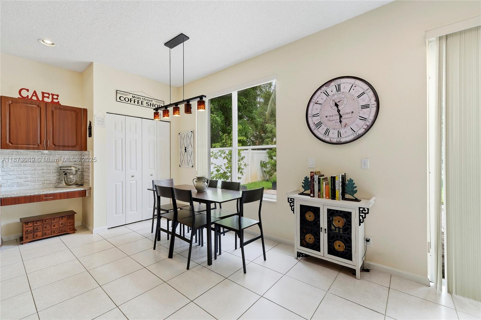 15025 Southwest 19th Court Miramar, FL 33027 - Photo 5 of 28 a dining room with furniture and a clock