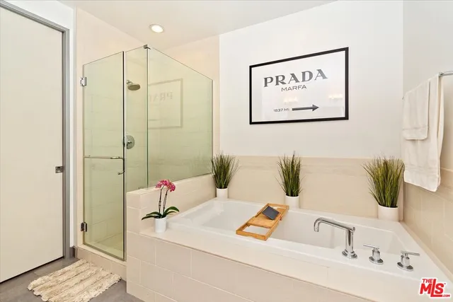 a bathroom with a tub sink and mirror