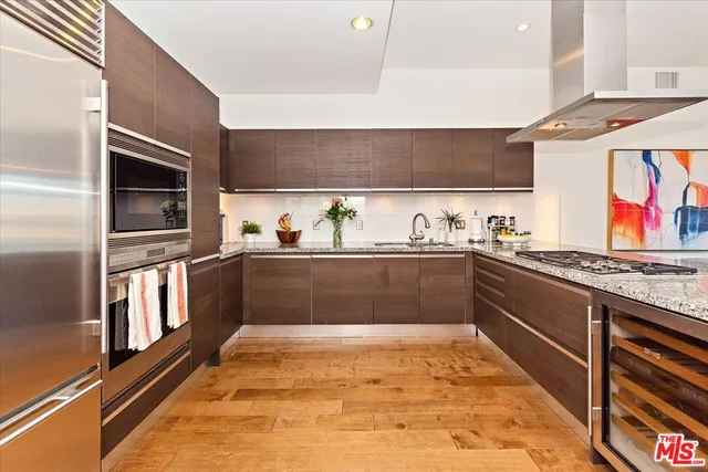a kitchen with stainless steel appliances granite countertop a stove and a sink