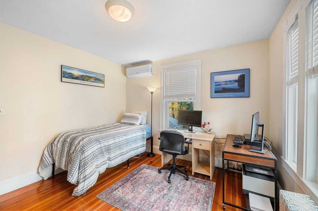 73 Orange Street, Unit 2 Waltham, MA 02453 - Photo 14 of 40 a bedroom with a bed and a desk