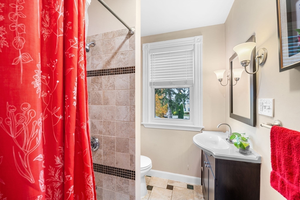 73 Orange Street, Unit 2 Waltham, MA 02453 - Photo 15 of 40 a bathroom with a sink a mirror and a shower