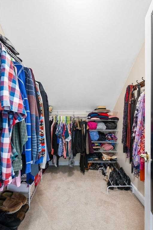 73 Orange Street, Unit 2 Waltham, MA 02453 - Photo 29 of 40 a view of walk in closet with clothes and shoes