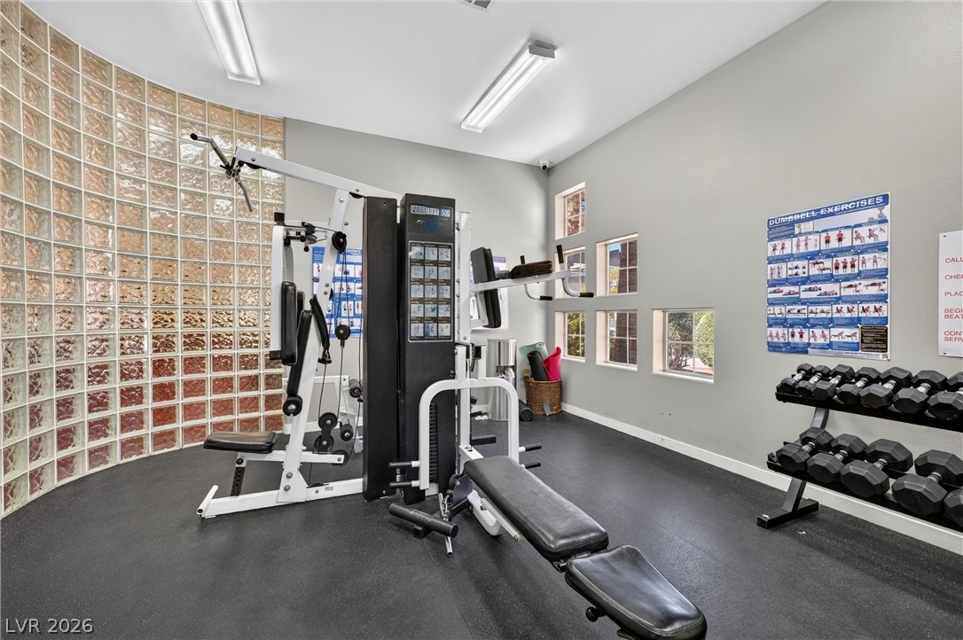 2247 Ramsgate Drive, Unit 2247 Henderson, NV 89074 - Photo 43 of 50 Fitness room offering a multi-station gym and free weights, illuminated by overhead lighting and natural light from multiple windows.