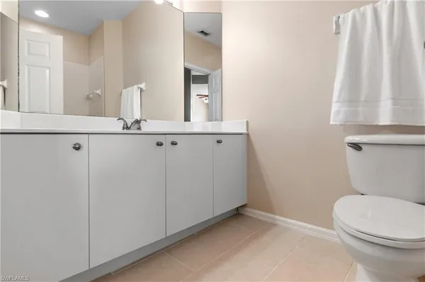 a bathroom with a sink a toilet a mirror and shower curtain