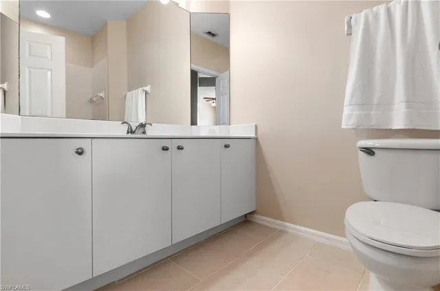 a bathroom with a sink a toilet a mirror and shower curtain