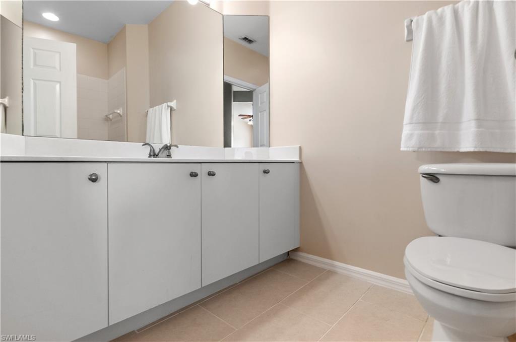 5940 Sand Wedge Lane, Unit 1407 Naples, FL 34110 - Photo 11 of 13 Full bath featuring light tile patterned floors, vanity, and walk in shower