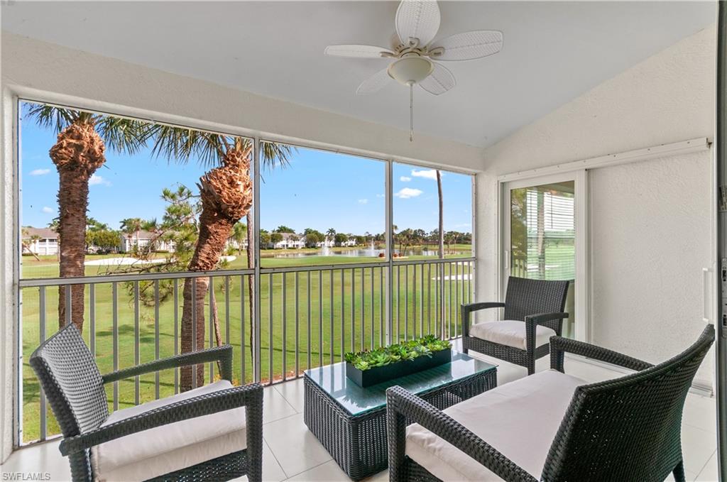 5940 Sand Wedge Lane, Unit 1407 Naples, FL 34110 - Photo 13 of 13 Sunroom / solarium featuring a water view, vaulted ceiling, and view of golf course