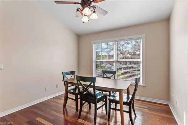 a view of a dining room with furniture window and wooden floor