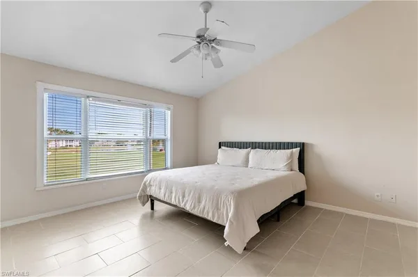 a bed sitting in a bedroom next to a window