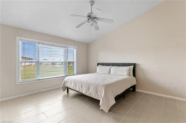 a bed sitting in a bedroom next to a window