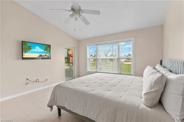 a bedroom with a large bed and a window