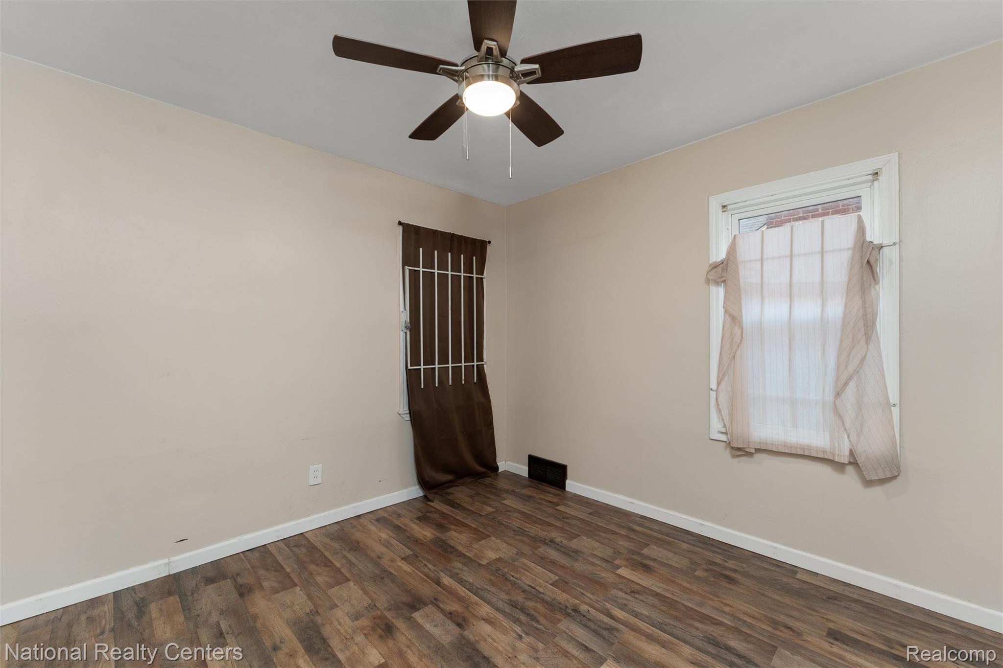 5525 Cadieux Road Detroit, MI 48224 - Photo 10 of 19 Spare room featuring dark wood finished floors and a ceiling fan