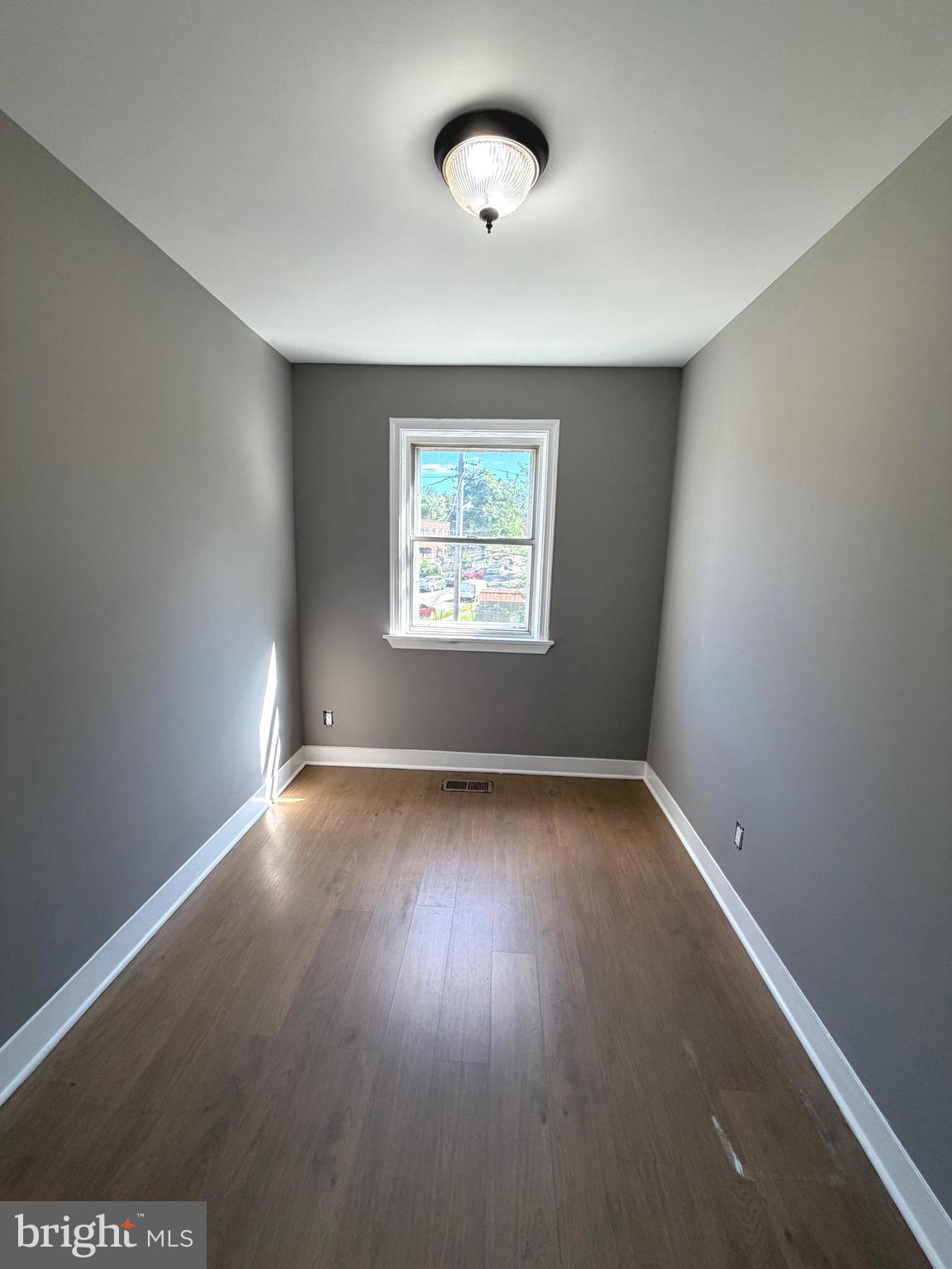 1353 Cambria Street Baltimore, MD 21225 - Photo 11 of 23 an empty room with a window