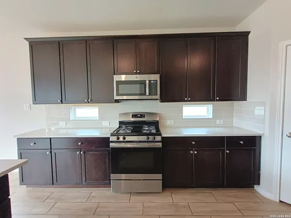 a kitchen with a sink and a stove top oven