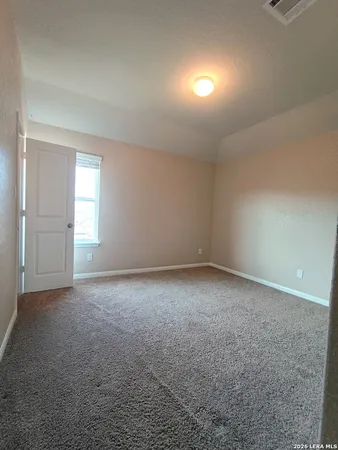 a view of empty room with fan and window
