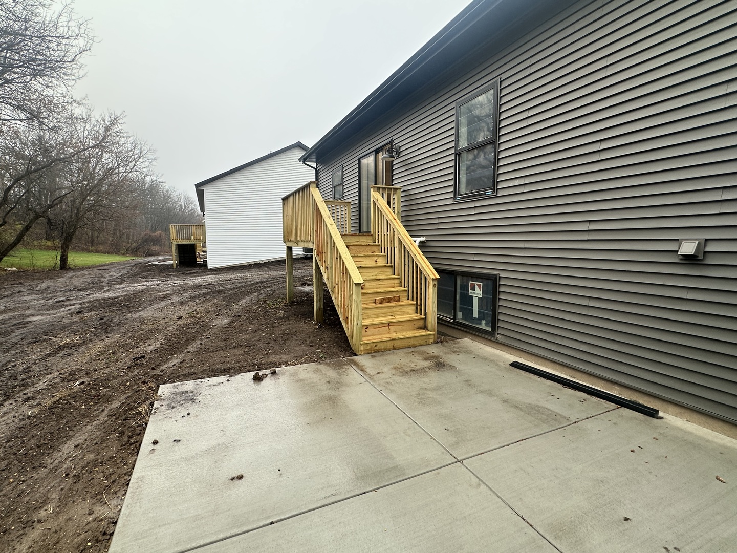 309 Creekside Drive Byron, IL 61010 - Photo 11 of 11 a view of a house with a patio