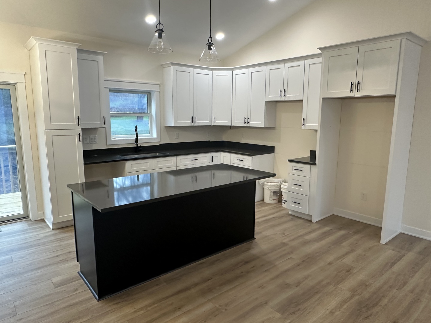 309 Creekside Drive Byron, IL 61010 - Photo 2 of 11 a kitchen with stainless steel appliances granite countertop a stove a refrigerator a sink and white cabinets with wooden floor