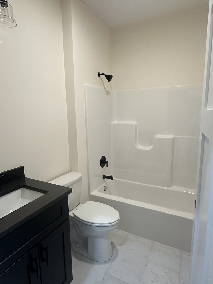 309 Creekside Drive Byron, IL 61010 - Photo 6 of 11 a bathroom with a sink a toilet and shower