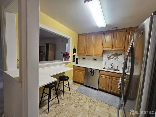 a kitchen with stainless steel appliances granite countertop a refrigerator stove and sink