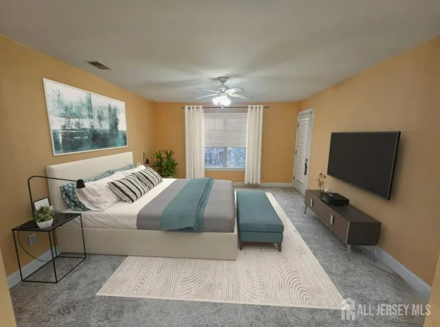 a bedroom with a large bed and a flat screen tv
