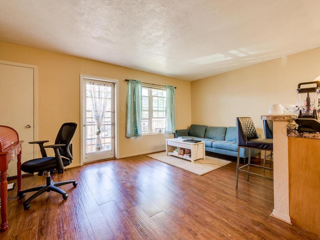 910 Duncan Lane, Unit 2 Austin, TX 78705 - Photo 2 of 11 Rich hardwood floors unite the living space, offering warmth and continuity.