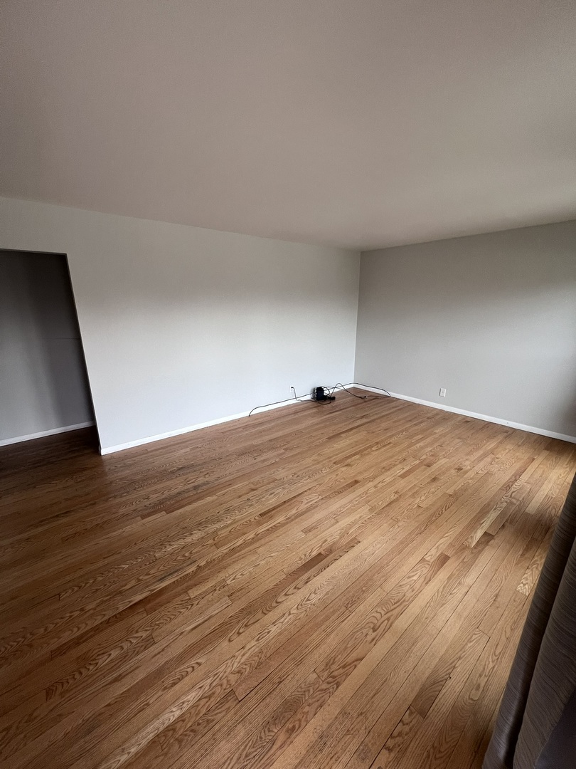 Undisclosed Address Chicago, IL 60656 - Photo 2 of 11 a view of an empty room with wooden floor