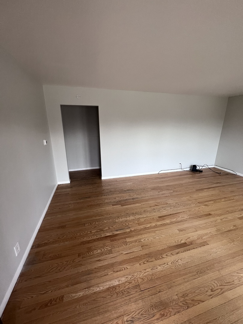 Undisclosed Address Chicago, IL 60656 - Photo 3 of 11 a view of an empty room and wooden floor