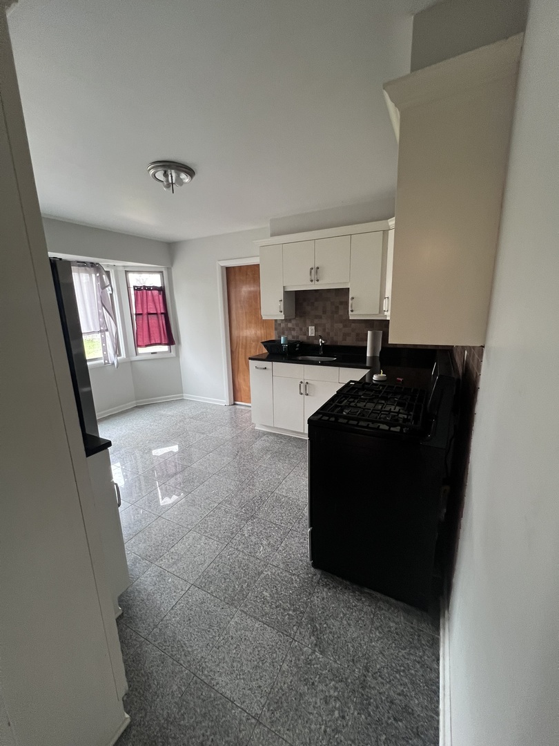 Undisclosed Address Chicago, IL 60656 - Photo 4 of 11 a living room with stainless steel appliances furniture and a fireplace