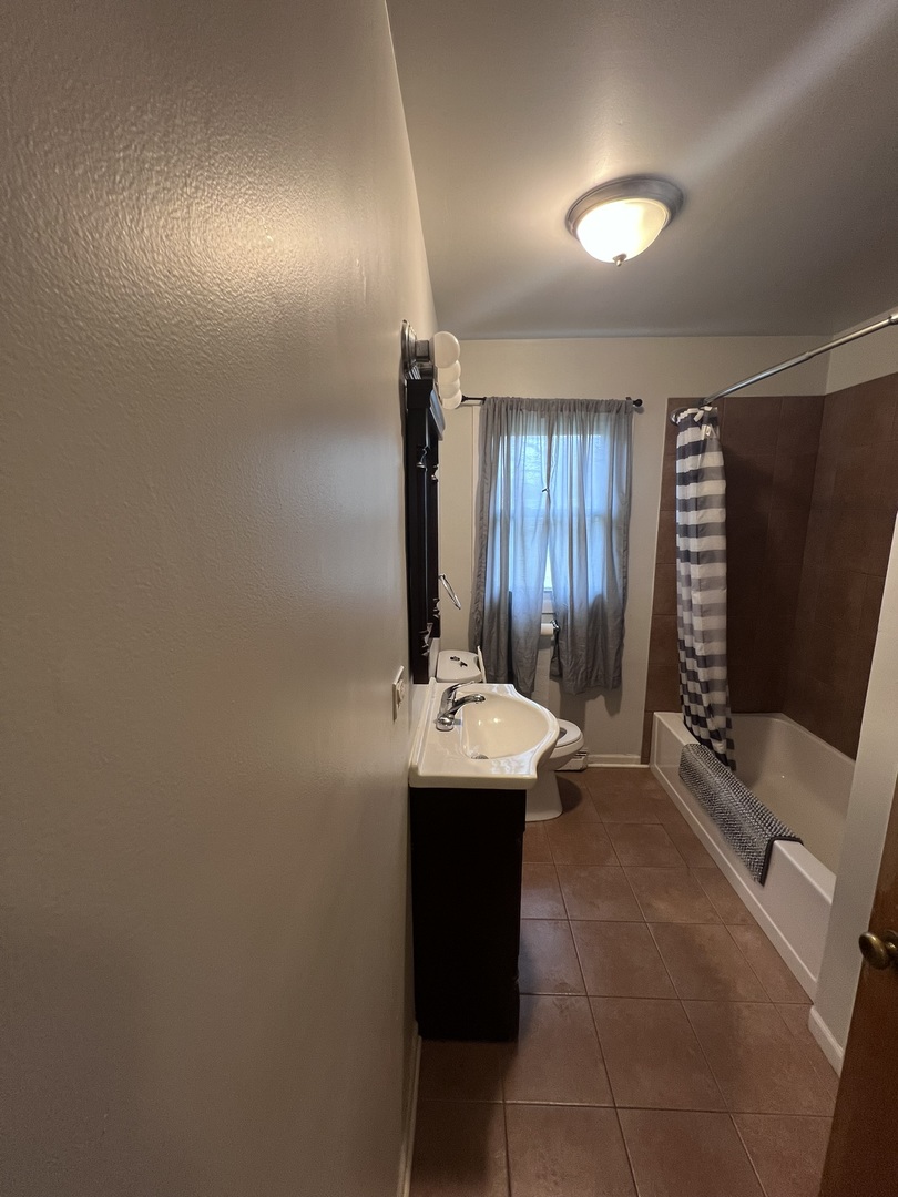 Undisclosed Address Chicago, IL 60656 - Photo 8 of 11 a bathroom with a sink and mirror with bathtub