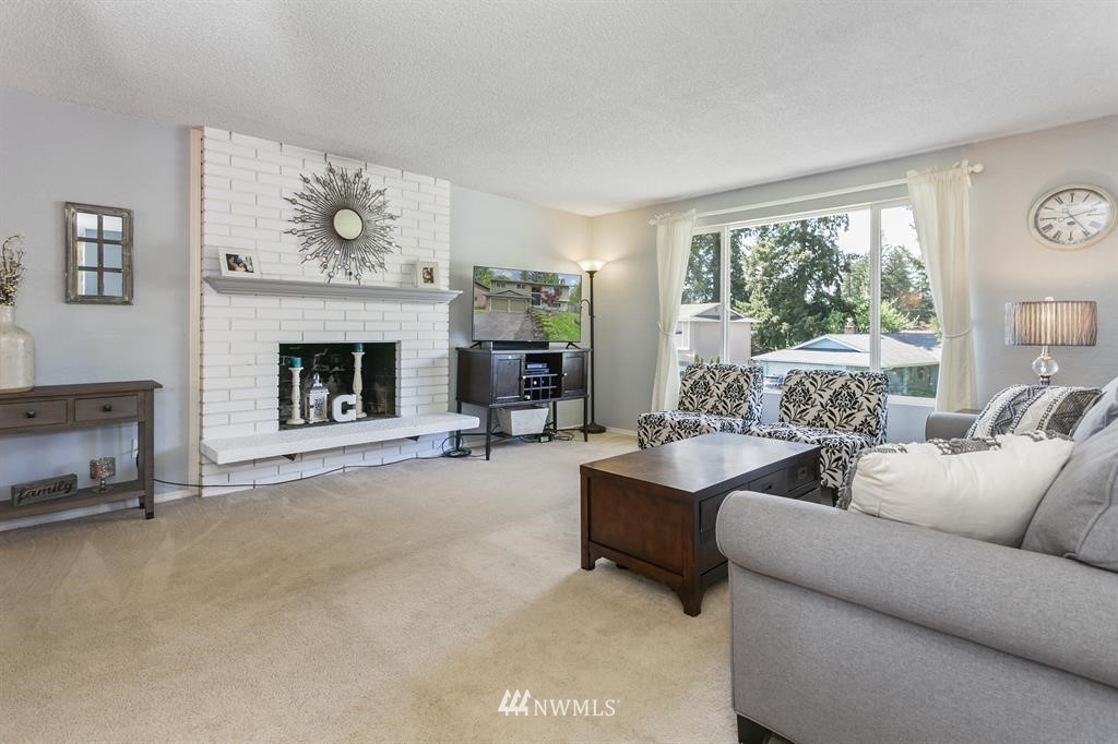 17405 Brook Boulevard Bothell, WA 98012 - Photo 2 of 25 a living room with furniture and a fireplace