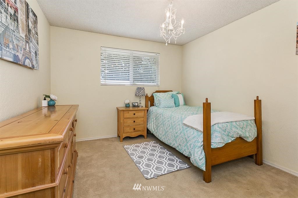 17405 Brook Boulevard Bothell, WA 98012 - Photo 11 of 25 a bedroom with a bed and a table