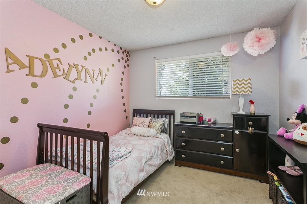 17405 Brook Boulevard Bothell, WA 98012 - Photo 12 of 25 a bedroom with a bed and a window
