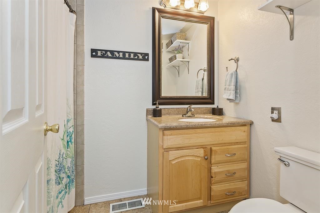 17405 Brook Boulevard Bothell, WA 98012 - Photo 13 of 25 a bathroom with a granite countertop sink toilet and shower