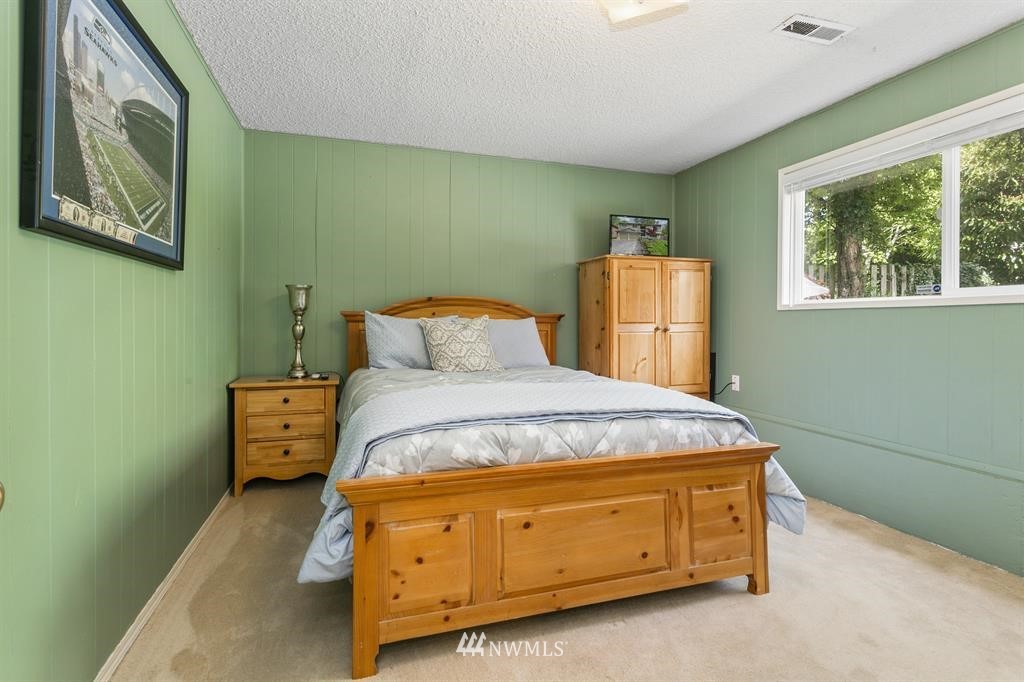 17405 Brook Boulevard Bothell, WA 98012 - Photo 17 of 25 a bedroom with a bed and window