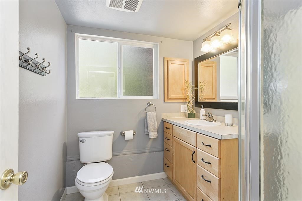 17405 Brook Boulevard Bothell, WA 98012 - Photo 18 of 25 a bathroom with a toilet sink and mirror