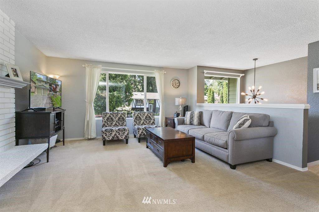 17405 Brook Boulevard Bothell, WA 98012 - Photo 3 of 25 a living room with furniture and large windows