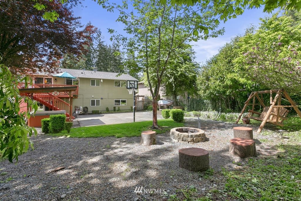 17405 Brook Boulevard Bothell, WA 98012 - Photo 23 of 25 a view of a backyard with table and chairs potted plants and a large tree