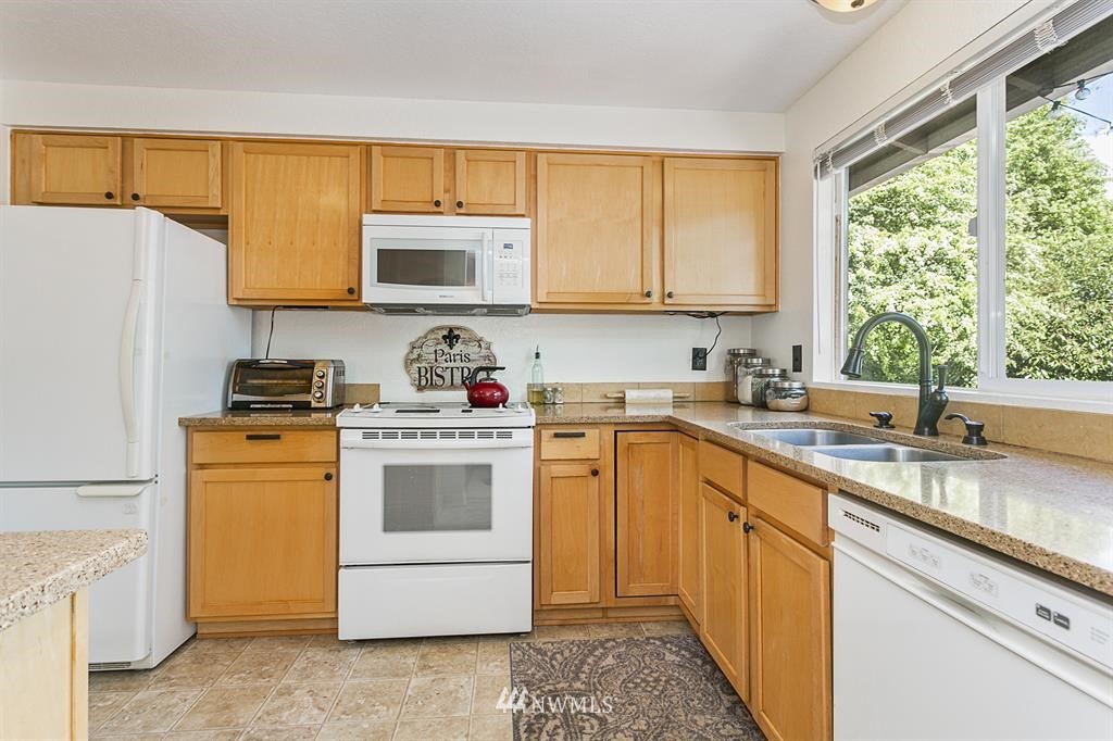 17405 Brook Boulevard Bothell, WA 98012 - Photo 5 of 25 a kitchen with a sink stove and refrigerator