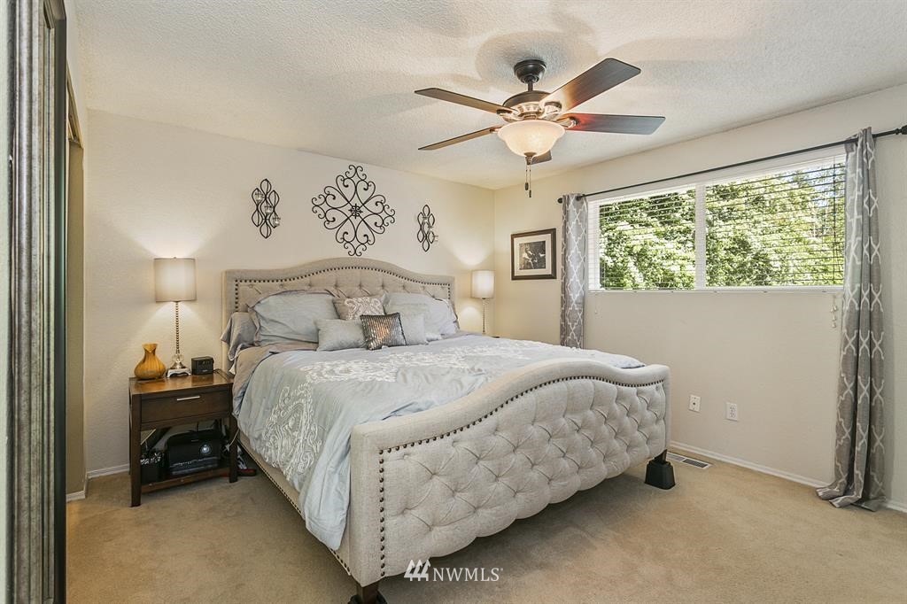 17405 Brook Boulevard Bothell, WA 98012 - Photo 8 of 25 a bedroom with a bed and window