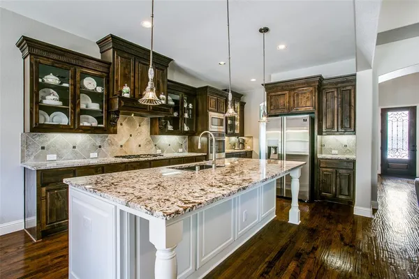 a kitchen with stainless steel appliances granite countertop a stove and refrigerator
