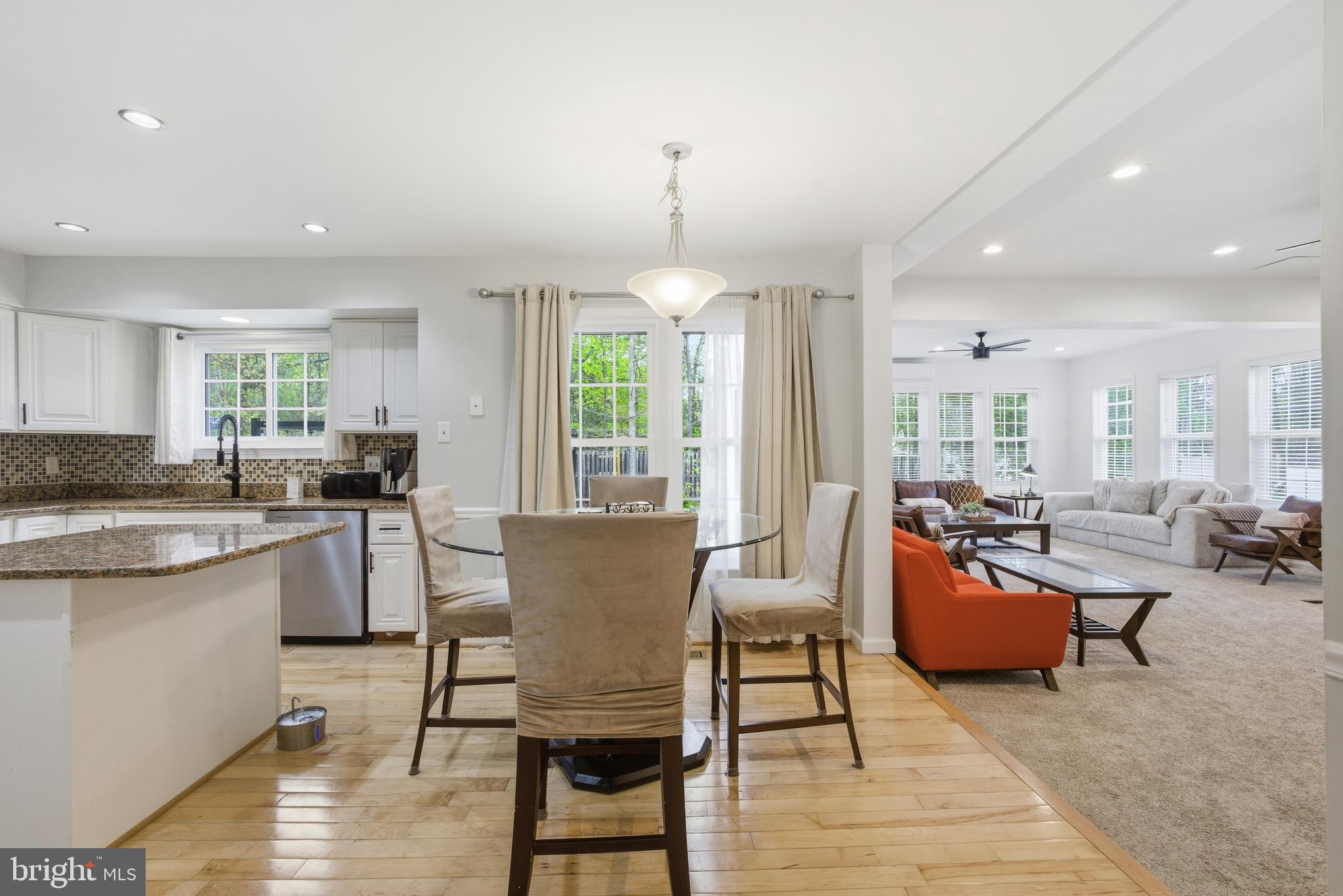 8664 Pohick Forest Court Springfield, VA 22153 - Photo 13 of 41 a living room with dining room and kitchen view