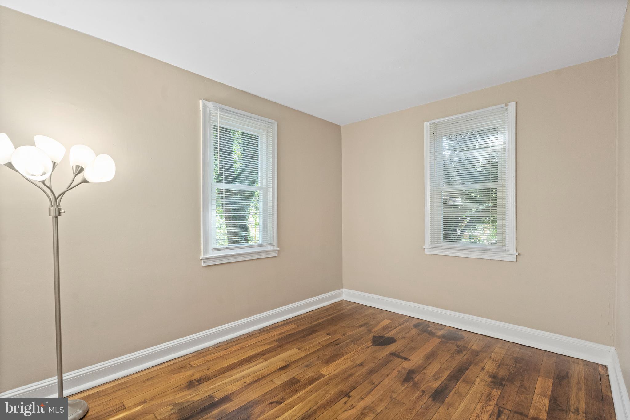 188 Cook Avenue Salem, NJ 08079 - Photo 11 of 25 a view of an empty room with wooden floor and a window