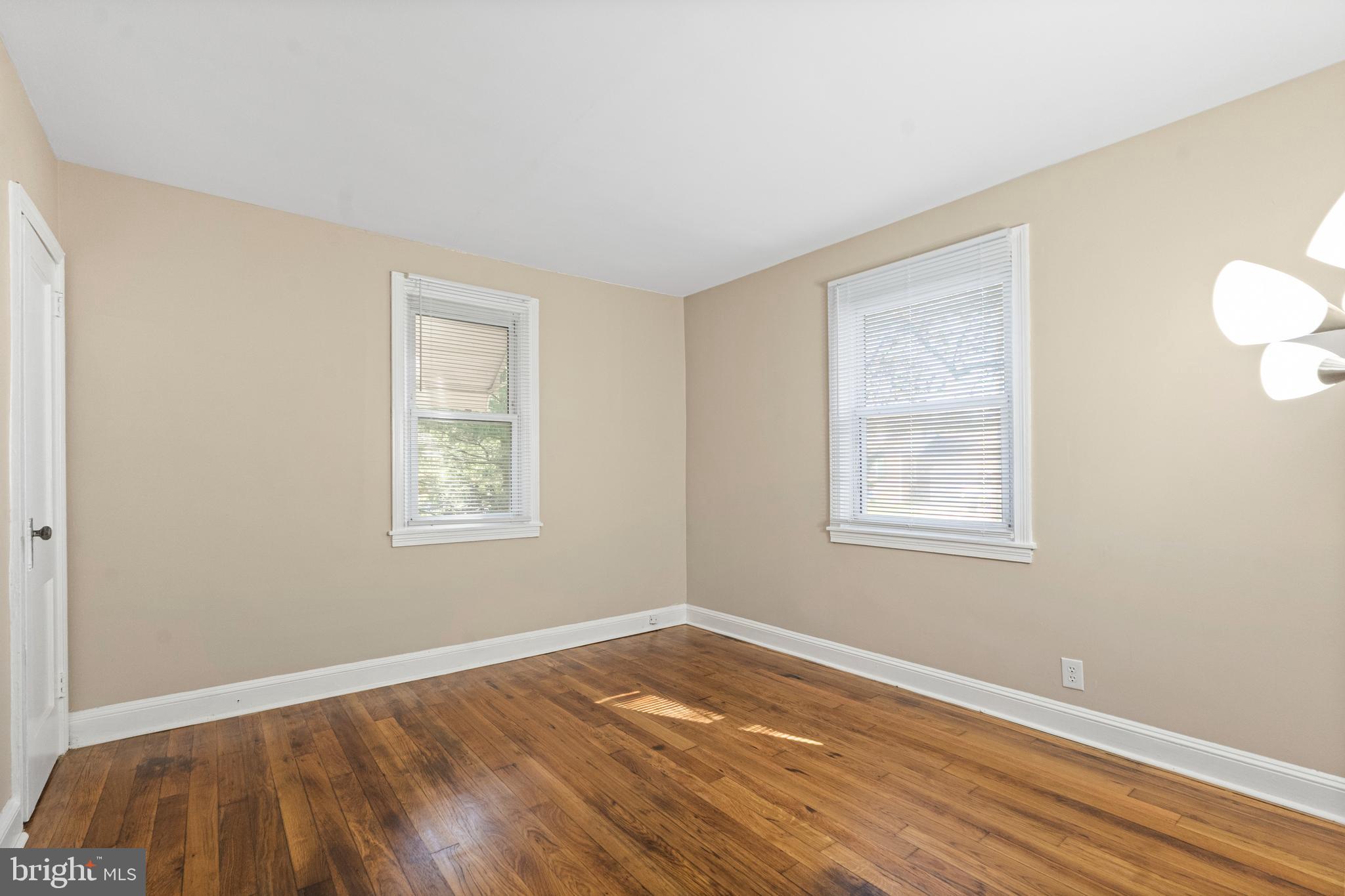 188 Cook Avenue Salem, NJ 08079 - Photo 13 of 25 a view of an empty room with wooden floor and a window