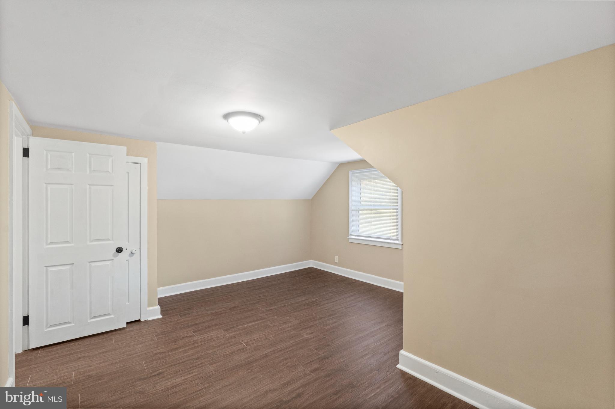 188 Cook Avenue Salem, NJ 08079 - Photo 16 of 25 an empty room with wooden floor and windows