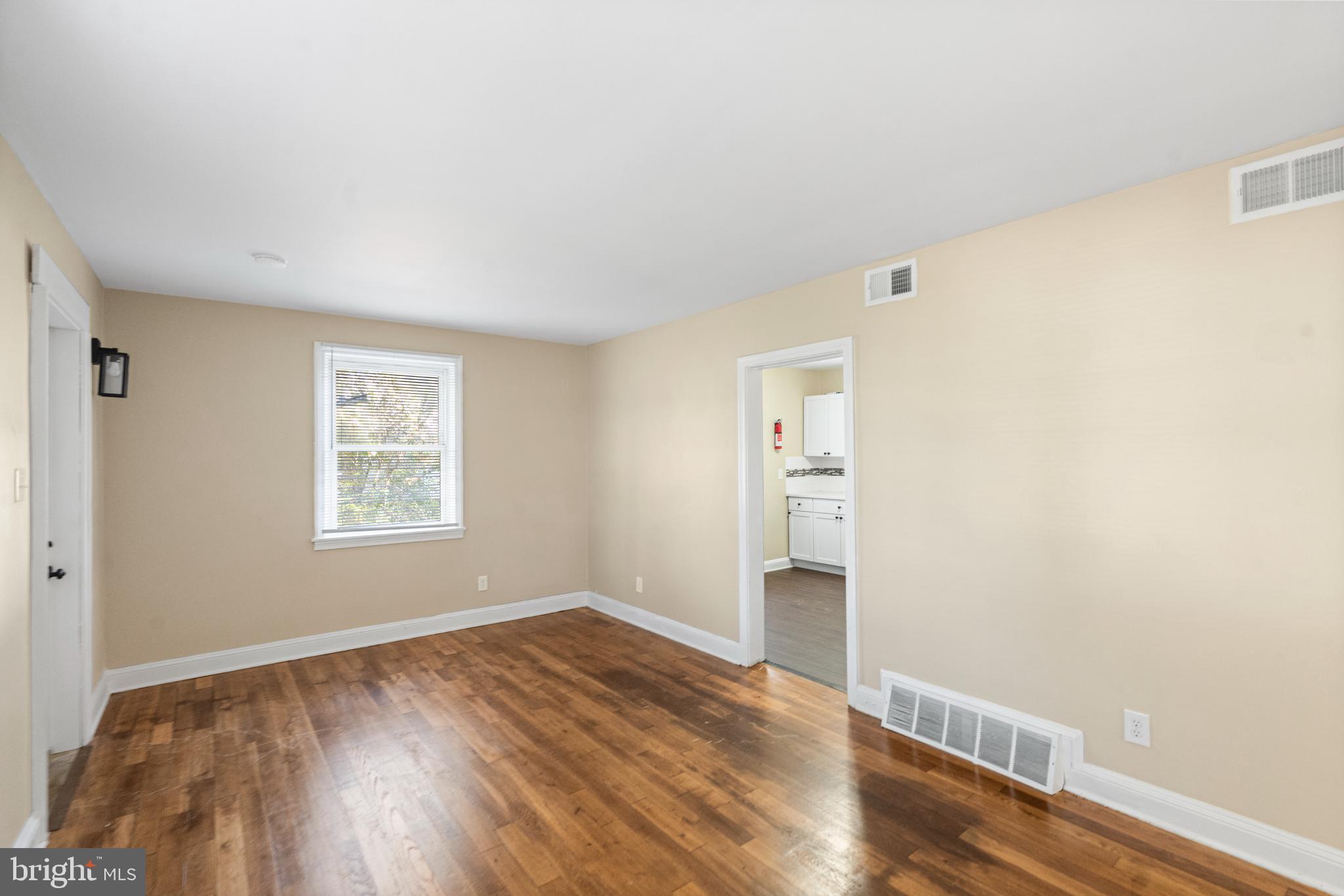 188 Cook Avenue Salem, NJ 08079 - Photo 6 of 25 an empty room with wooden floor and window