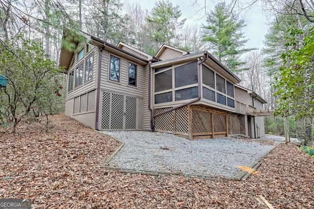 a view of a hallway with a dining table and chandelier