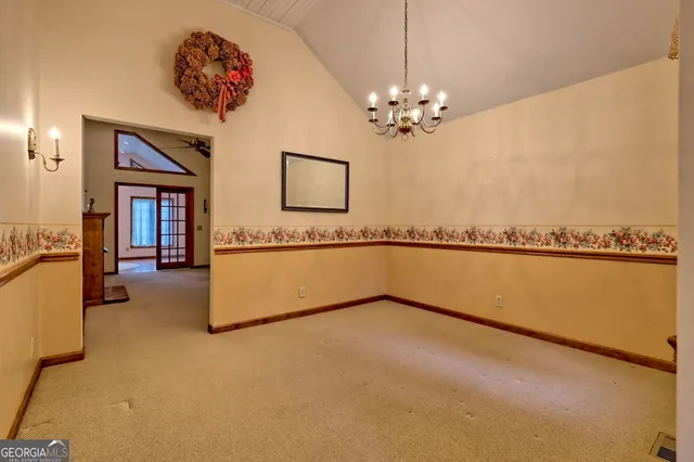 a view of a livingroom with wooden floor and a ceiling fan