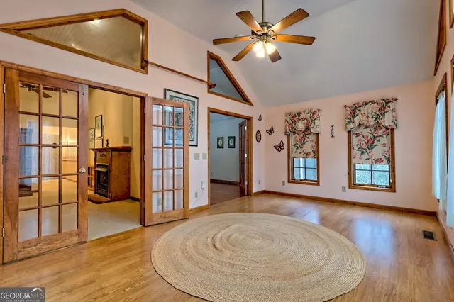 a view of a hallway with wooden floor and staircase